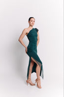 Woman wearing a green one-shoulder dress on a white background