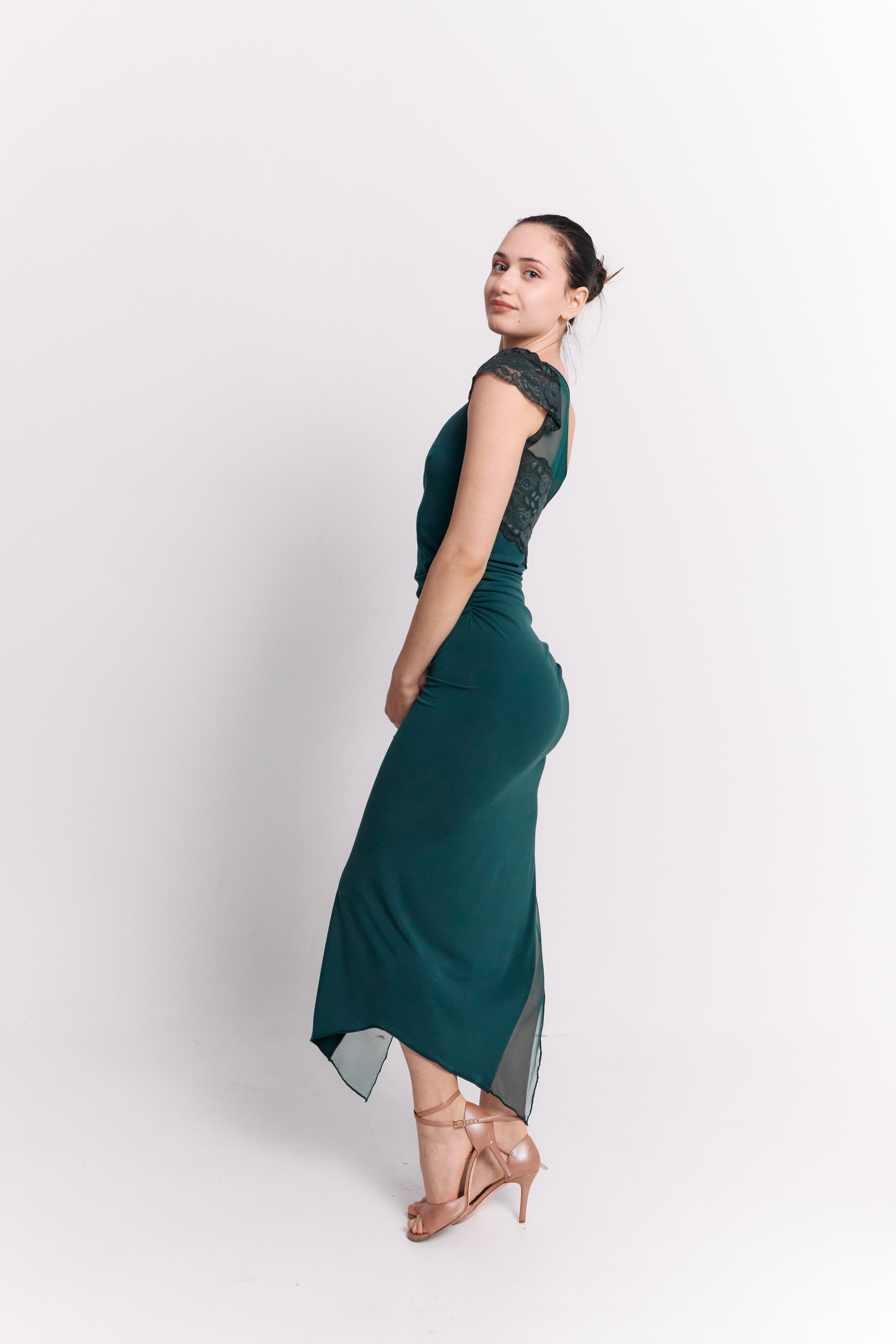 Woman wearing a green dress against a white background