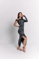 Woman wearing a black and white leopard patterned dress on a white background
