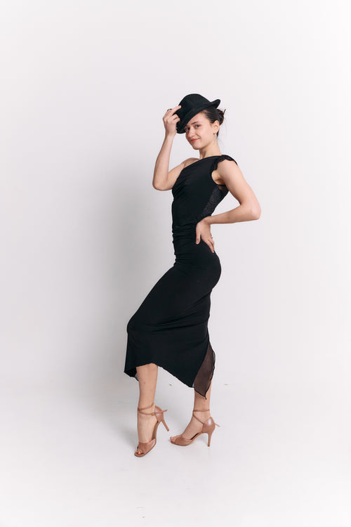 Woman wearing a black dress and hat against a white background