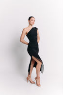 Woman wearing a black one-shoulder dress on a white background