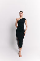 Woman wearing a black one-shoulder dress on a white background