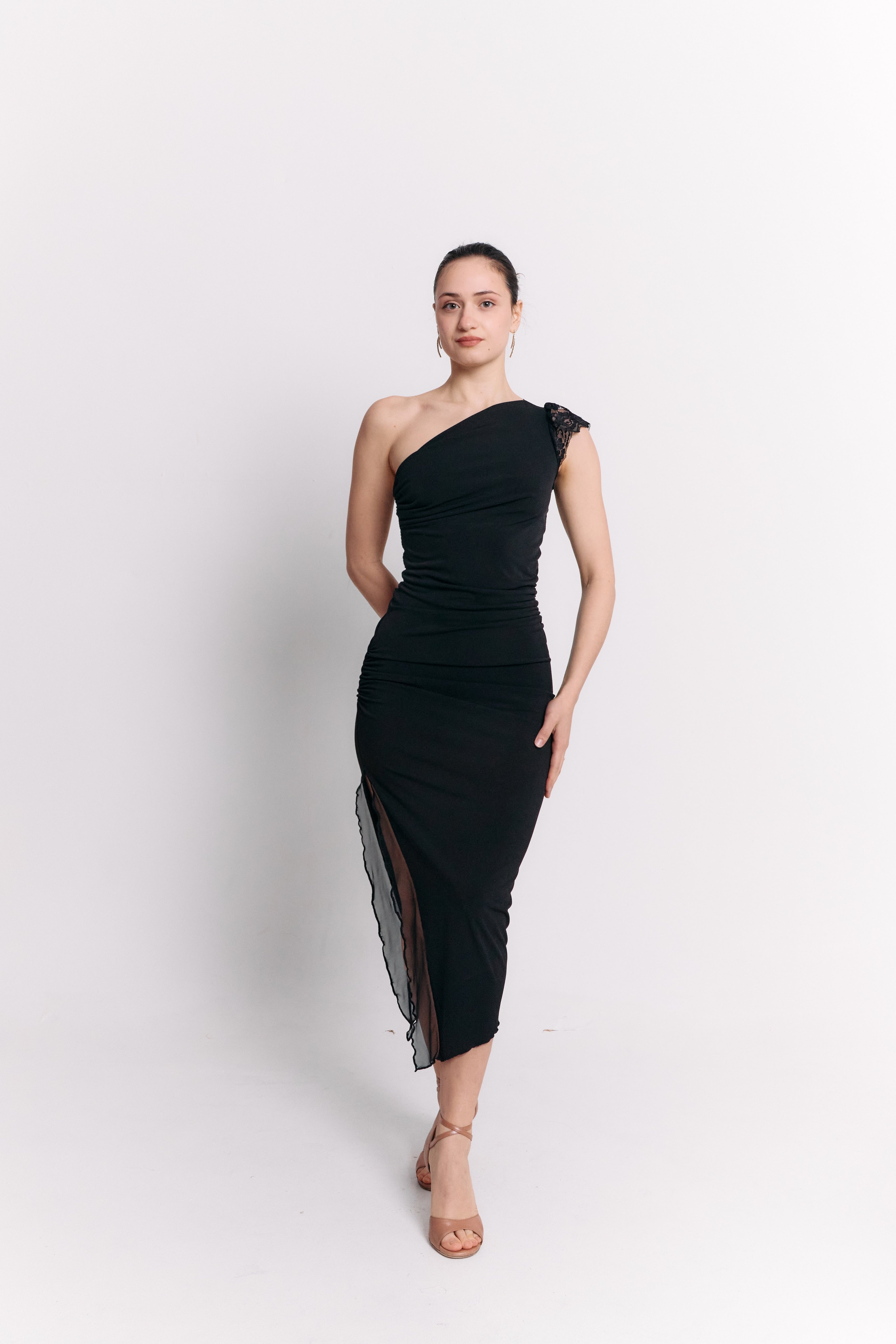 Woman wearing a black one-shoulder dress on a white background