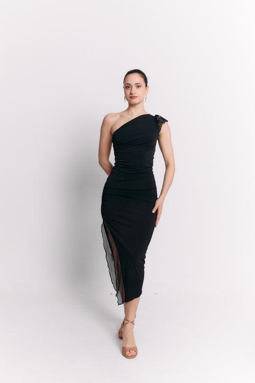 Woman wearing a black one-shoulder dress on a white background