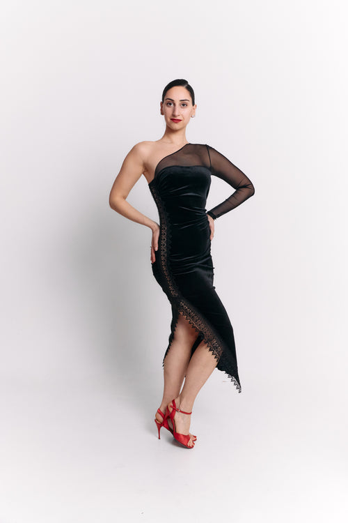 Woman wearing a black dress with sheer sleeve on a white background