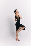 Woman in a black dress against a white background