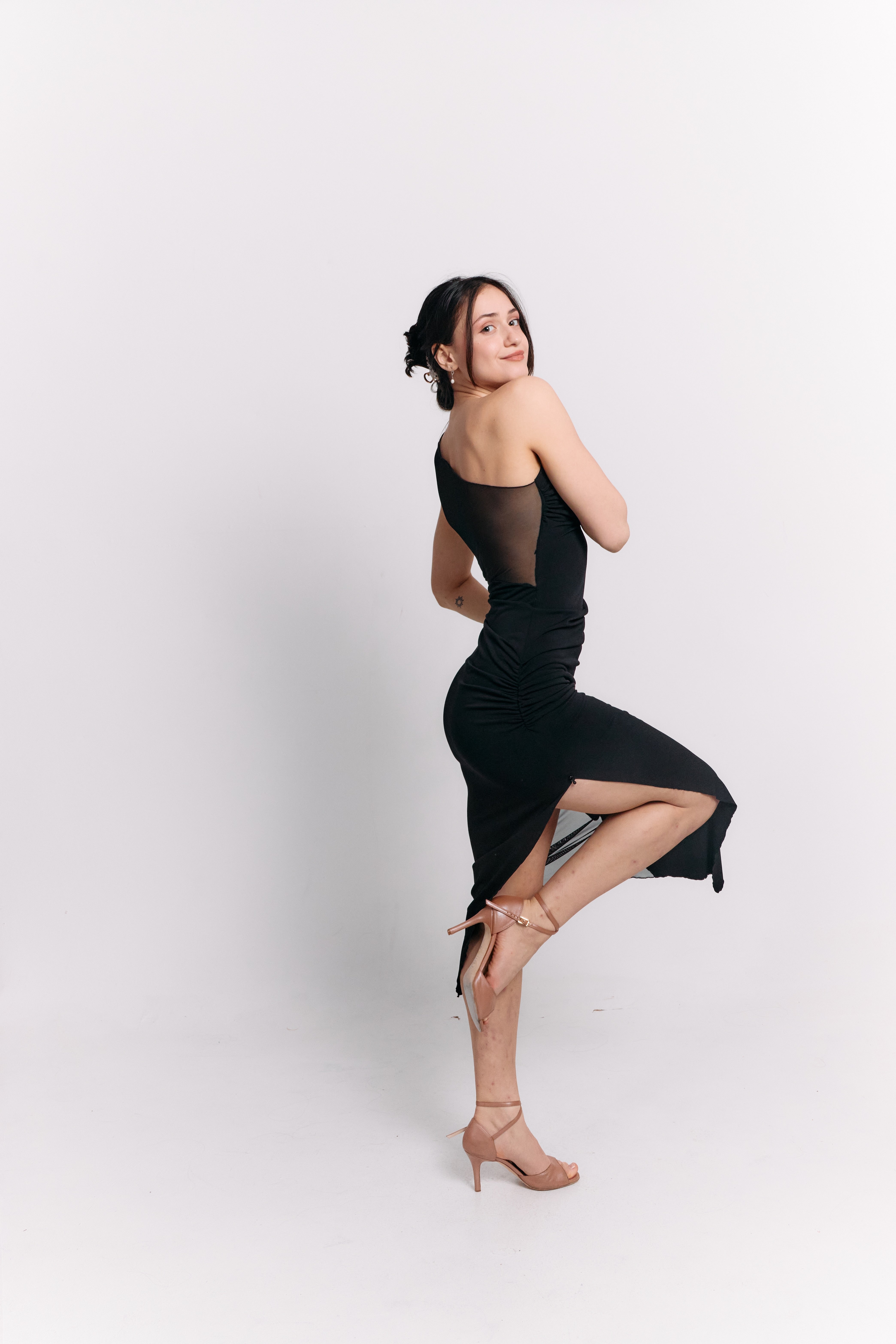 Woman in a black dress against a white background