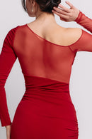 Woman wearing a red dress with long sleeves on a white background