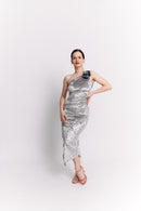 Woman wearing a silver one-shoulder dress on a white background