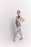 Woman wearing a silver dress against a white background