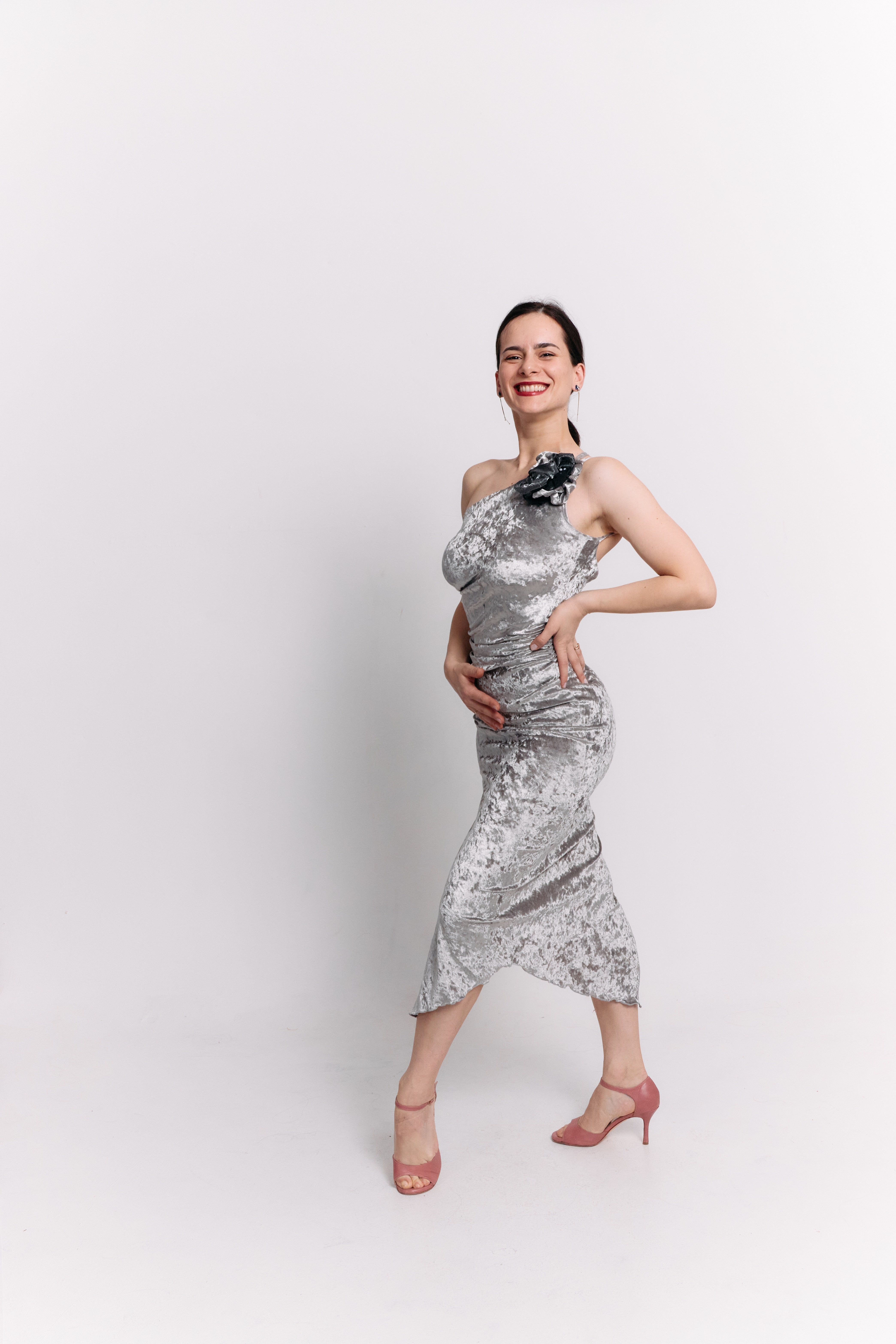 Woman wearing a silver dress against a white background