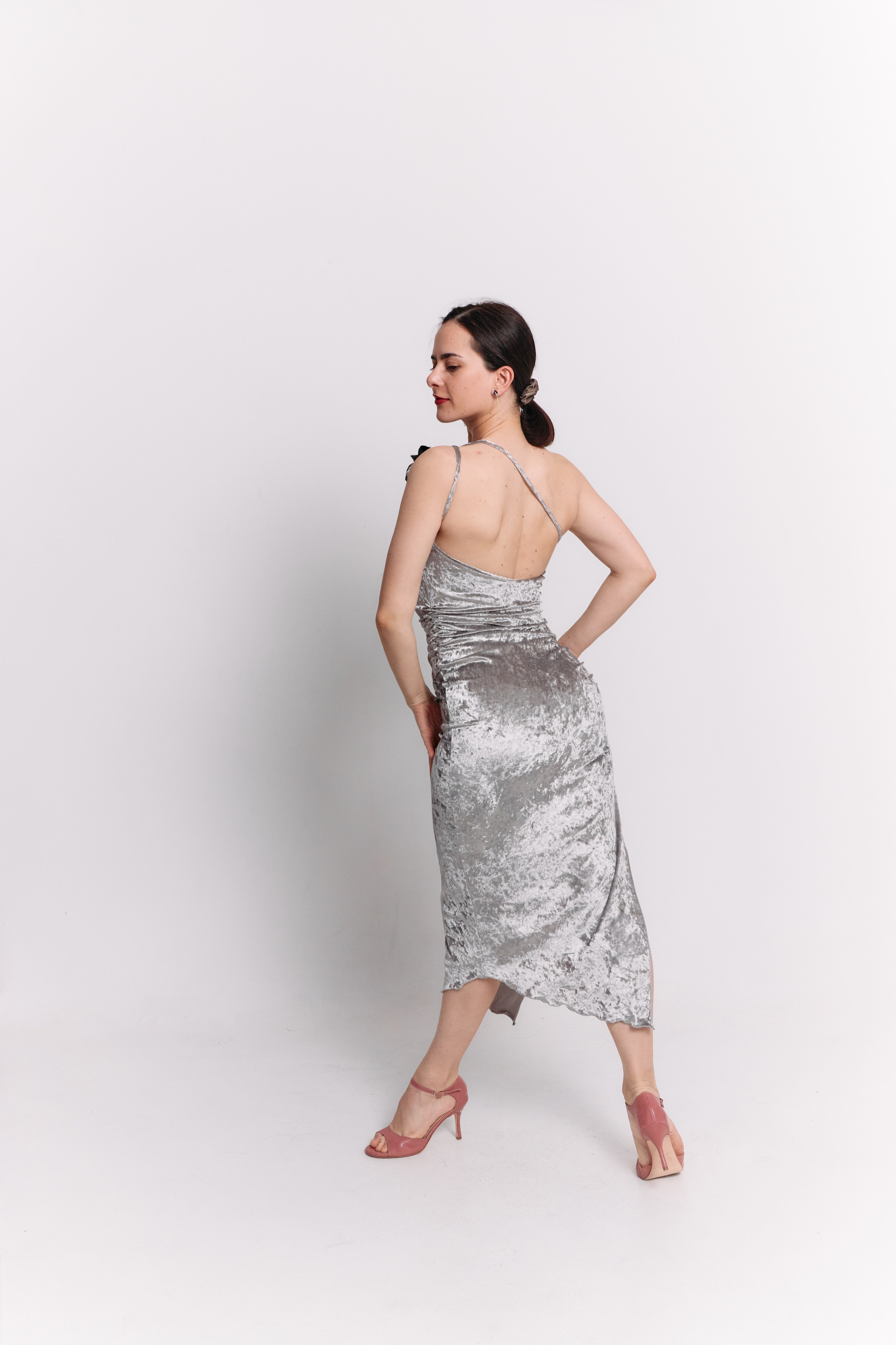 Woman wearing a silver dress against a white background