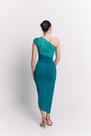 Woman wearing a turquoise one-shoulder dress on a white background