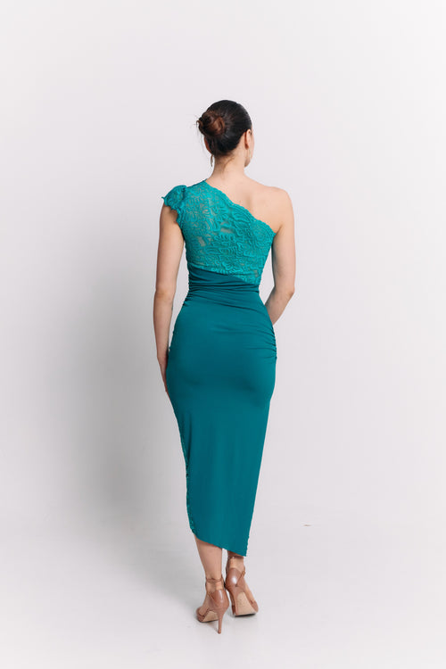 Woman wearing a turquoise one-shoulder dress on a white background